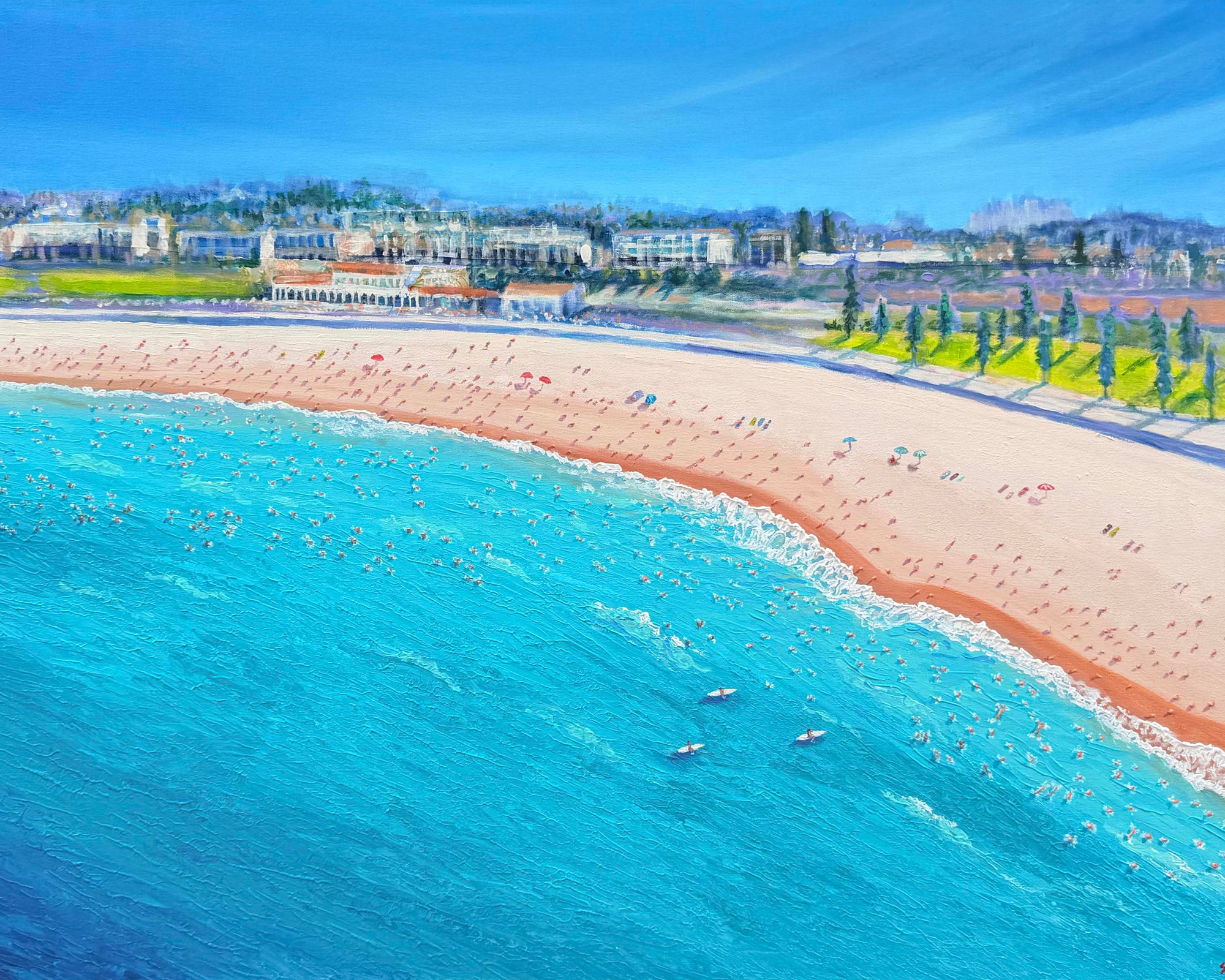 Framed artwork of a beach scene with blue water and sandy shore.